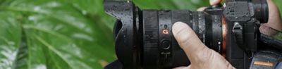 Image of a man holding the α7R V while its surface is wet