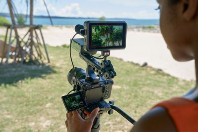Photographer shooting with handle and monitor