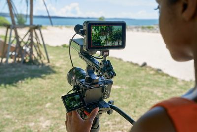 Photographer shooting with handle and monitor