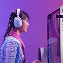 A gamer sitting at their computer wearing the INZONE H5 headphones