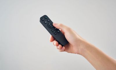 Image of a hand holding the HT-S2000 remote