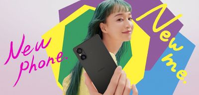 Image of a person holding an Xperia phone on a pink background with colourful shapes and text 'New phone. New me.'