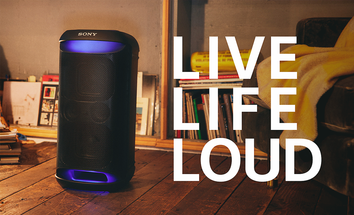 The SRS-XV500 in a stylish home, illuminated with blue lighting. Overlaying the image are the words 'LIVE LIFE LOUD'