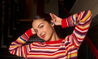 Olivia Rodrigo wearing a pair of violet LinkBuds Open earbuds.