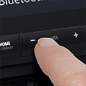 Close up of a finger pressing one of the XAV-AX8500 buttons