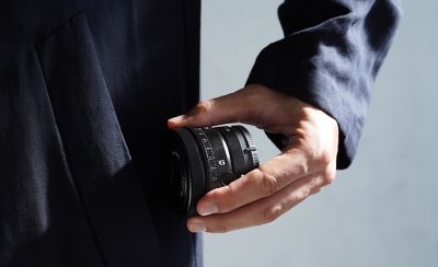 Image of person taking out lens from pocket