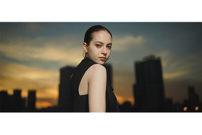 Image of a woman taken with flash in front of sunset