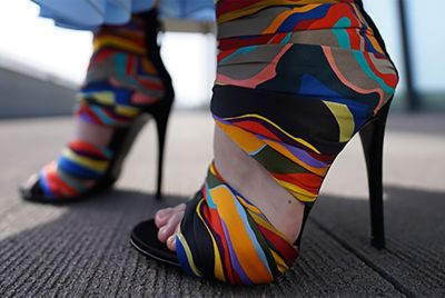 Image of colourful high heels taken at the shortest possible distance, with the hem of the skirt smoothly blurred