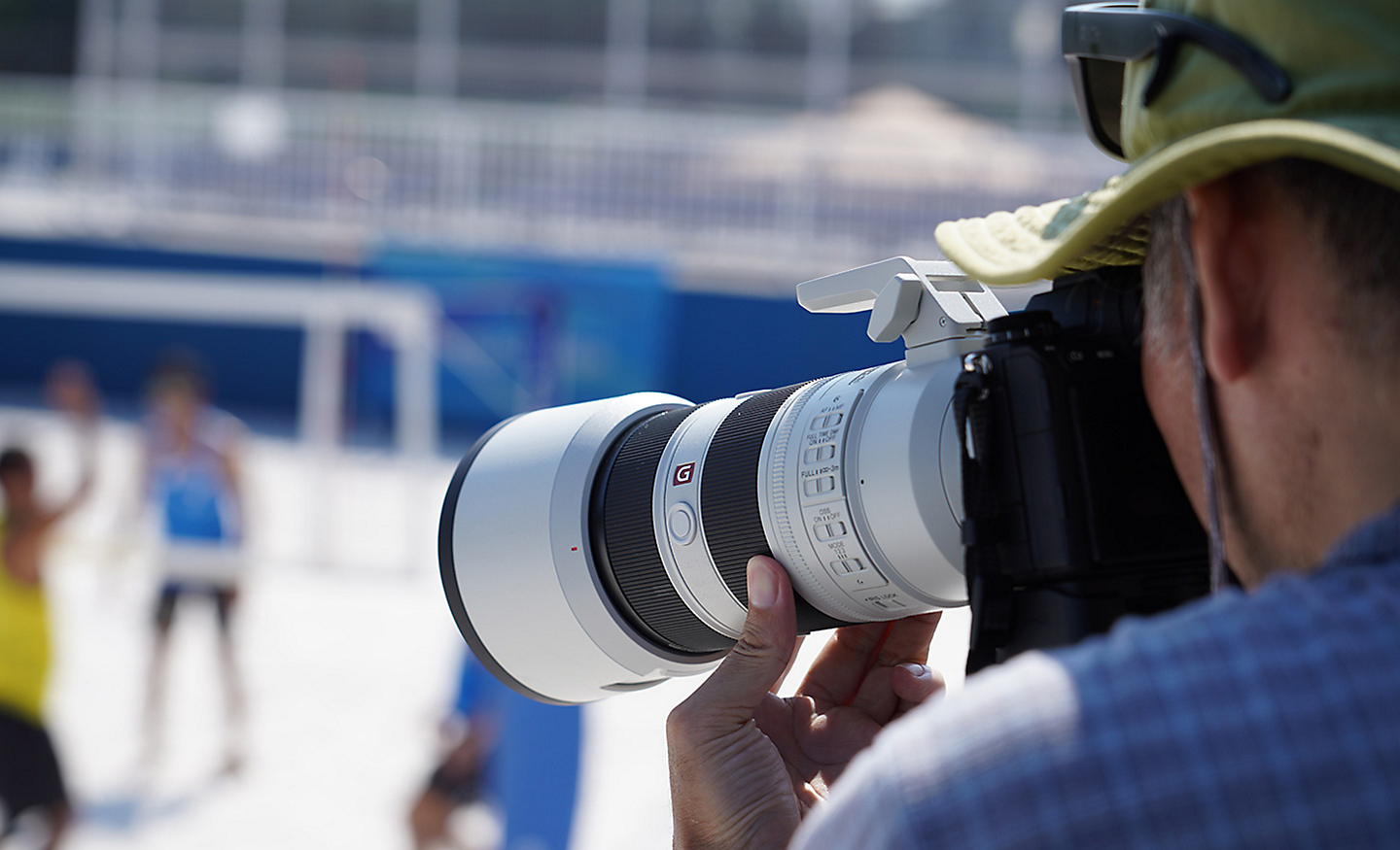 Photographer shooting a game of beach volleyball