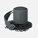 Image of the black SRS-XB100 speaker sitting on granules of matching coloured plastic