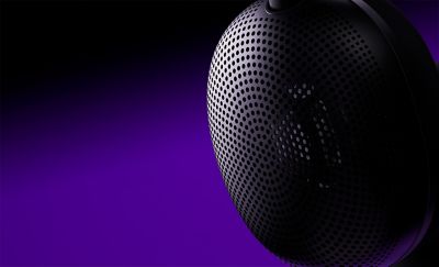 black headphone speaker on a black and purple background