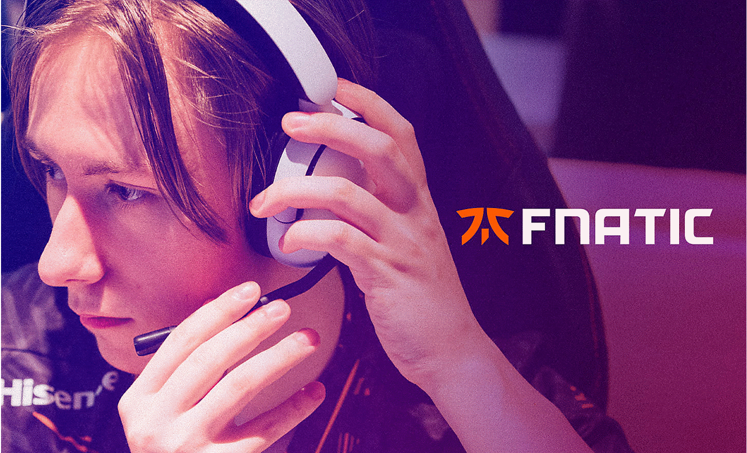 A FNATIC gamer adjusting the microphone on the INZONE H5 headphones