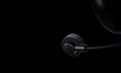 Close up of  black headphone mic and ear cup on a black background
