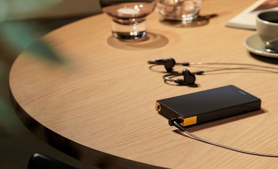 ภาพ NW-ZX707 ที่วางอยู่บนโต๊ะและเสียบเข้ากับหูฟัง