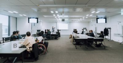 Employees are working on a workshop in a conference room