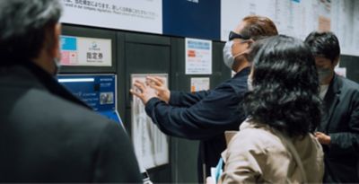 The lead user is buying a ticket at a ticket vending machine