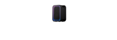 A studio product shot shows the black Sony ULT TOWER 5 party speaker standing vertically and angled slightly to the side against a plain, light background. The speaker's front rectangular mesh grille is framed by a glowing purple, blue, and cyan LED light strip, with the prominent circular "ULT" button brightly illuminated in the upper-left corner. Built-in carry handles are visible integrated into the top and bottom of the speaker's matte black side panel.