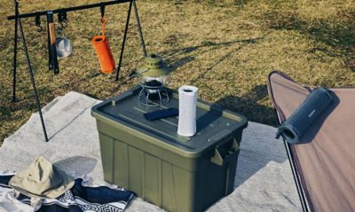 Image of three ULT FIELD 1 portable speakers and camp goods