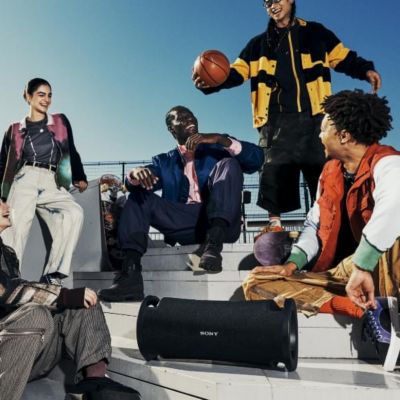 Image of ULT FIELD 7 portable speaker and group of young people sitting on the stairs