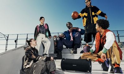 Image of ULT FIELD 7 portable speaker and group of young people sitting on the stairs