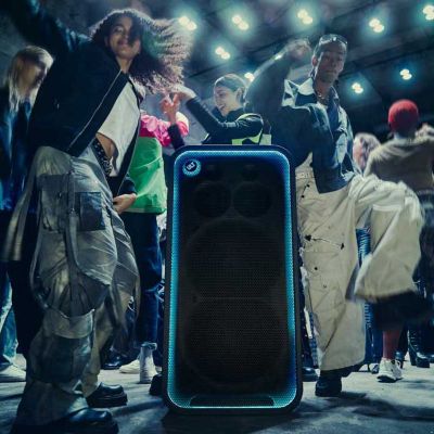 Muchas personas bailando y disfrutando de la música alrededor del ULT TOWER MAX en una discoteca.