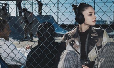 Image of a young female wearing ULT WEAR headphones