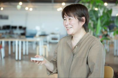 Employee holding recycled plastic material in hand